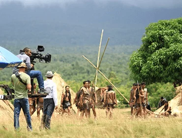 Production unit filming in a mountain landscape