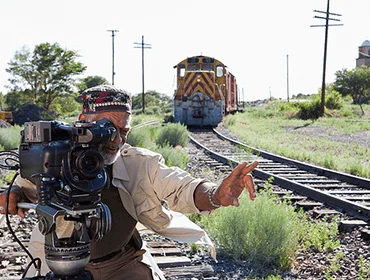 Operator lining up a shot beside a railway