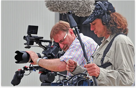 Two camera operators working a rig together